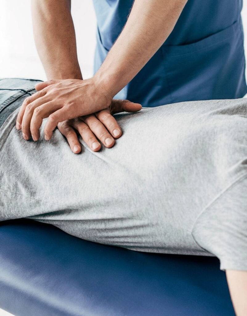 Chiropractor adjusting lower back